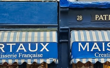 EIFA EIFA celebrated Architecture Day with a nod to the storied elegance of Maison Bertaux, a patisserie featuring classic blue awnings and striped canopies. Established in 1871, its decorative windows proudly display pastries and the famed Celebrated Tea Rooms signage.