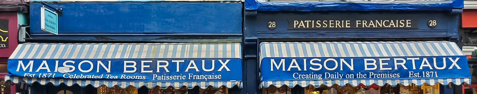 EIFA EIFA celebrated Architecture Day with a nod to the storied elegance of Maison Bertaux, a patisserie featuring classic blue awnings and striped canopies. Established in 1871, its decorative windows proudly display pastries and the famed Celebrated Tea Rooms signage.